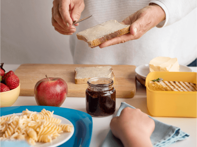 Person Buttering Bread